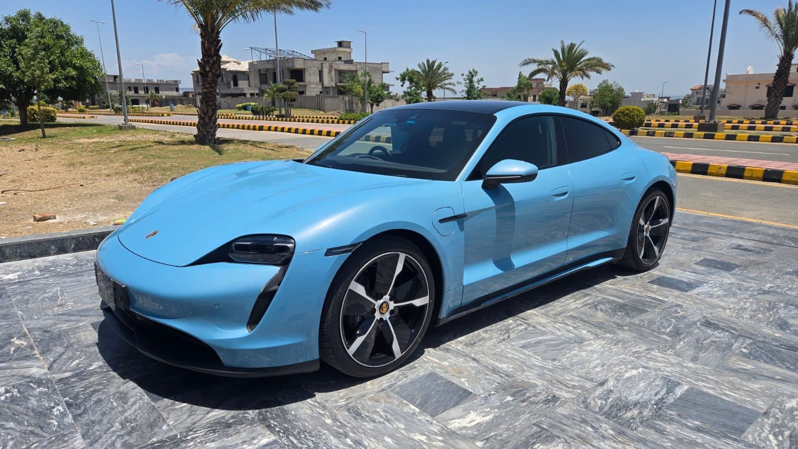 Porsche Taycan in light blue for rent at RideOnTours